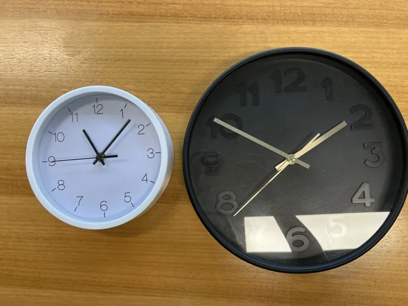 Two wall clocks - white and black