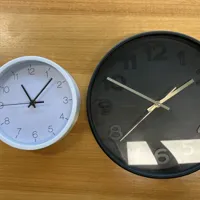 Two wall clocks - white and black