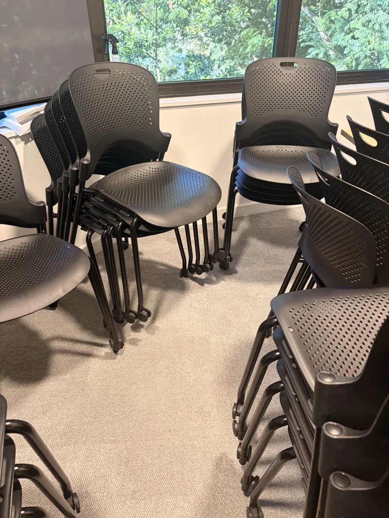 Black Stacking Chairs with Perforated Seat
